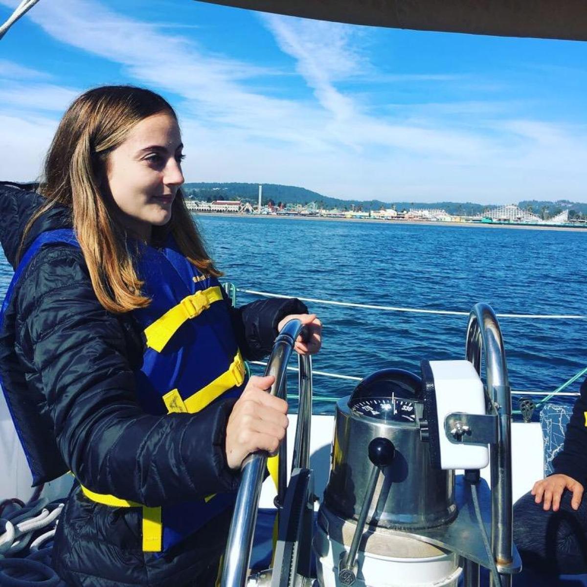 A girl driving a boat